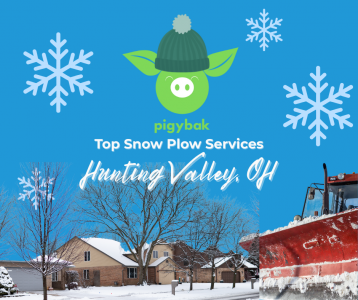 Snowy wooded driveway in Hunting Valley, Ohio being cleared by a professional snow plow crew.