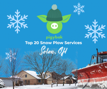 Snow plow clearing a parking lot in Solon, Ohio during a winter storm