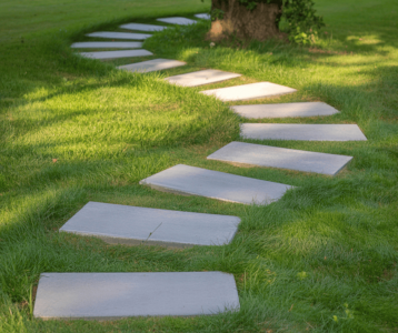 Stone walkway slabs forming a curved path across a grassy yard to illustrate simple outdoor navigation design